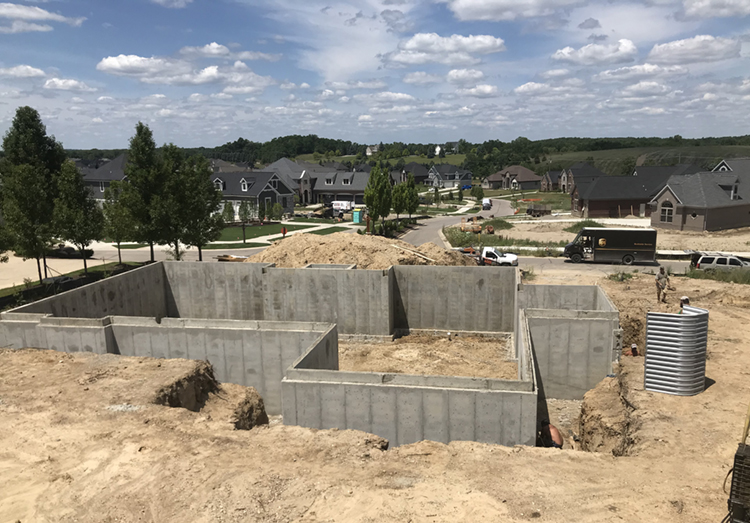photo of a home foundation being built in a housing development.