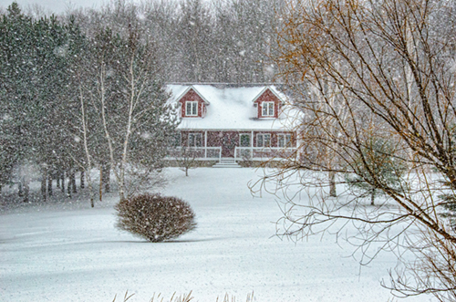 house in winter covered in snow